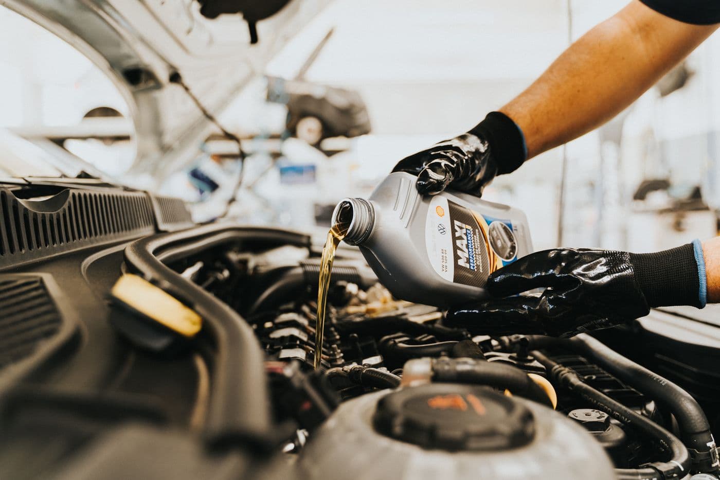 Mechanic working a repair stage in the engine bay