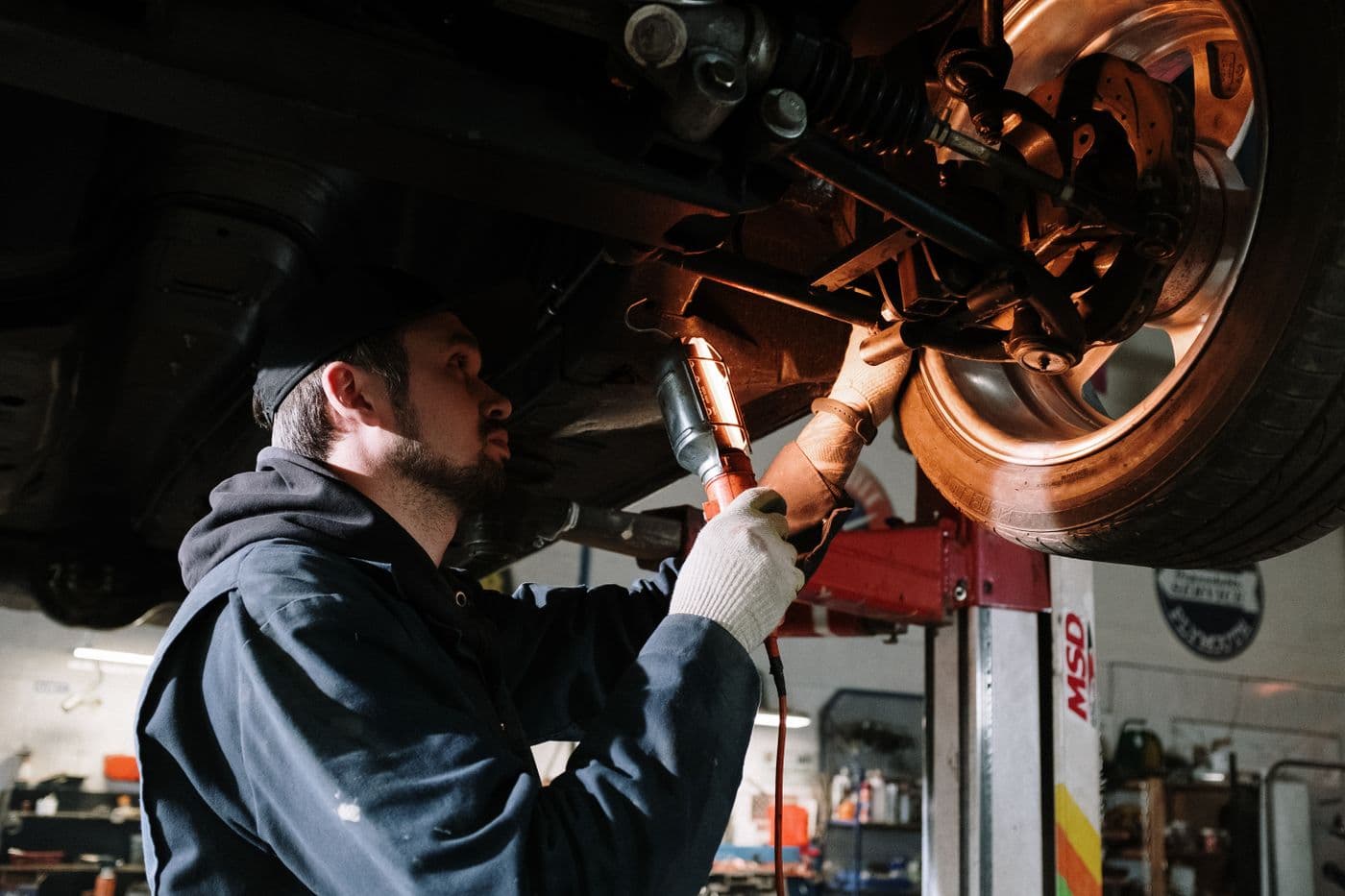 Technician diagnosing a vehicle on the lift